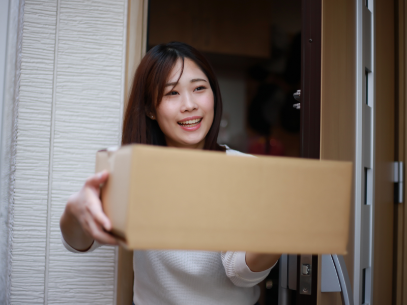 Woman receiving a discreet cannabis delivery at her door in Waterloo from I Love Smoke